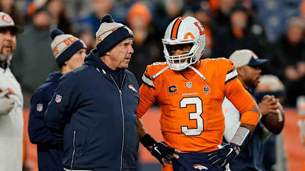 Denver Broncos head coach Sean Payton talks with quarterback Russell Wilson (3) before the game against the New England Patriots at Empower Field at Mile High.
